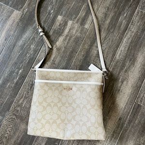 Coach crossbody approximately 9.5 x 11 with adjustable strap.